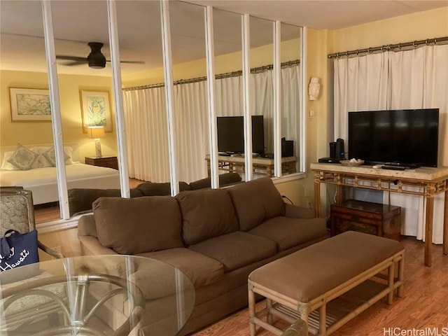 living room featuring ceiling fan and hardwood / wood-style flooring