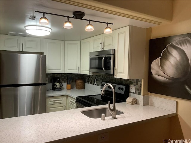 kitchen featuring decorative backsplash, sink, pendant lighting, and appliances with stainless steel finishes