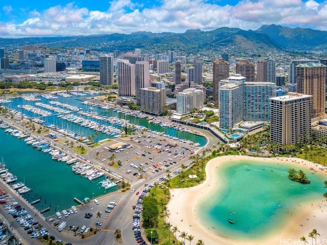 birds eye view of property with a view of the beach and a water and mountain view