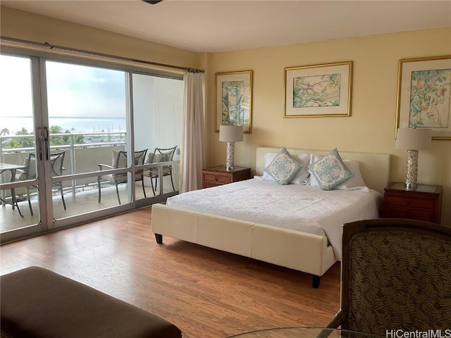 bedroom featuring french doors, access to outside, and light hardwood / wood-style flooring