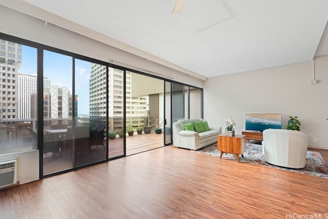 unfurnished living room with a textured ceiling and light wood-type flooring