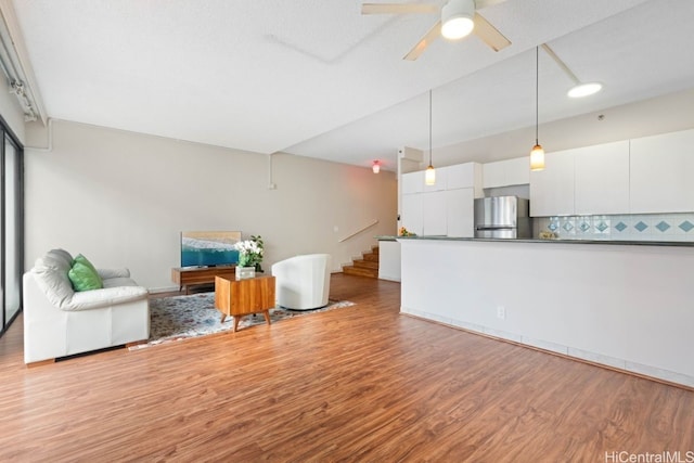 living room with ceiling fan and light hardwood / wood-style floors