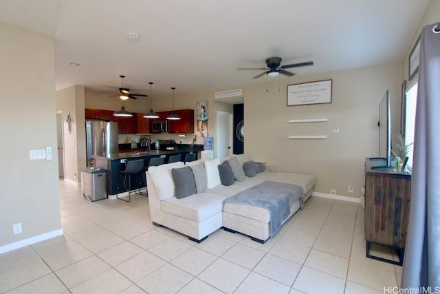 tiled living room with ceiling fan