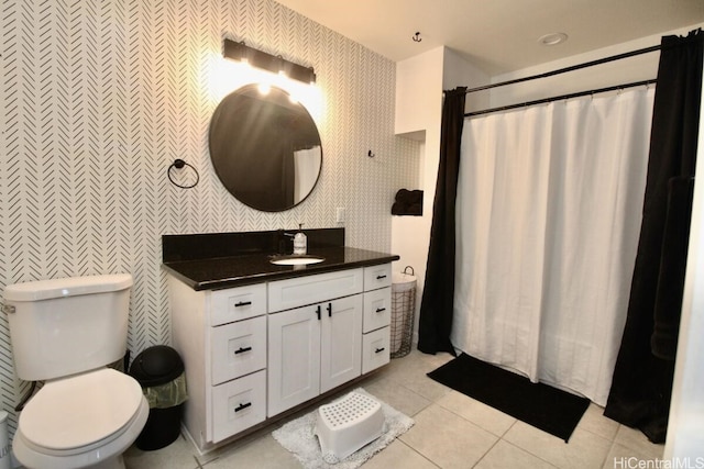 bathroom with toilet, vanity, tile patterned floors, and curtained shower