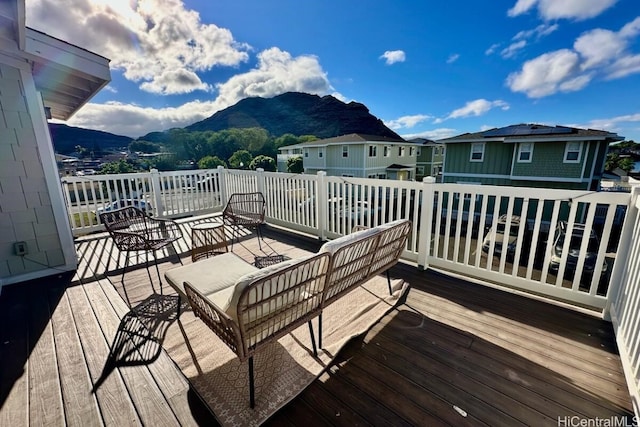 wooden terrace featuring a mountain view and an outdoor hangout area