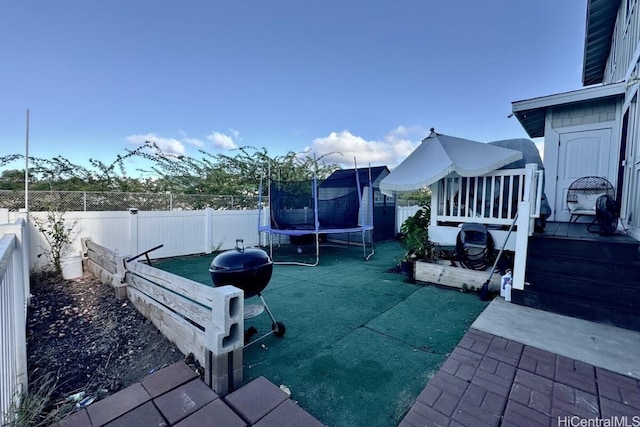 view of patio featuring a deck and a trampoline