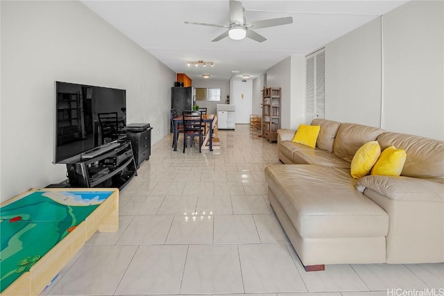 living room with ceiling fan and light tile patterned flooring