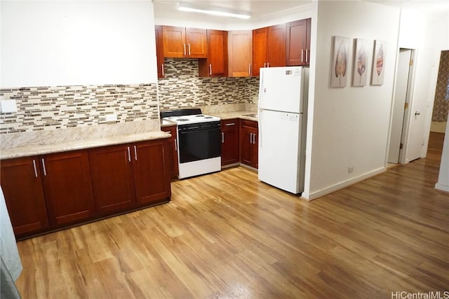 kitchen with white appliances, tasteful backsplash, light stone countertops, and light wood finished floors