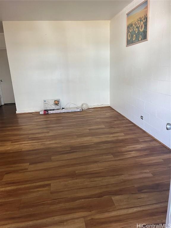 empty room with dark hardwood / wood-style floors