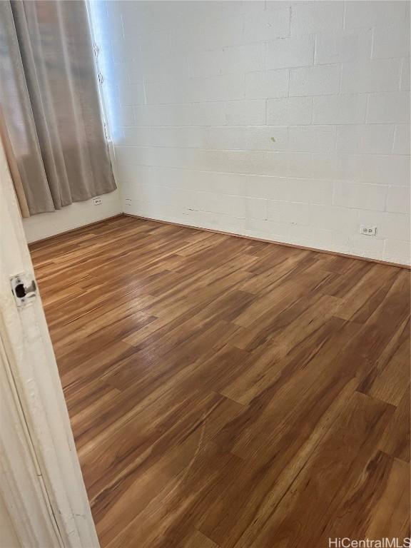 empty room with hardwood / wood-style flooring