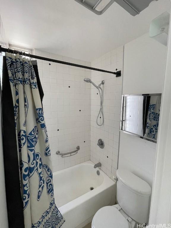 bathroom featuring shower / bath combo and toilet