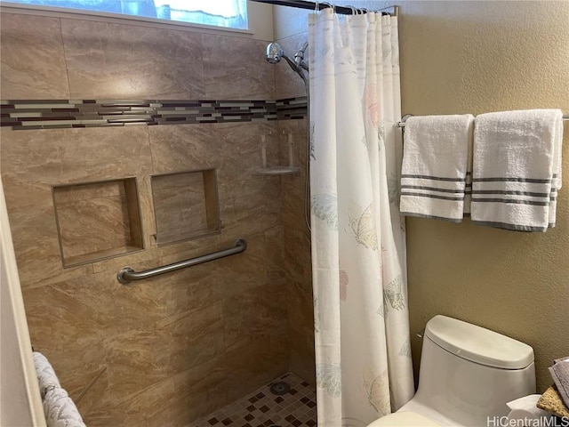 bathroom featuring curtained shower and toilet