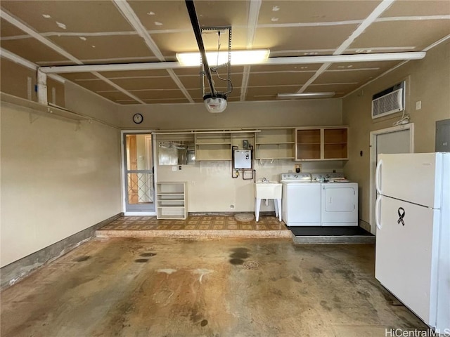 garage featuring electric panel, white refrigerator, an AC wall unit, sink, and washing machine and clothes dryer