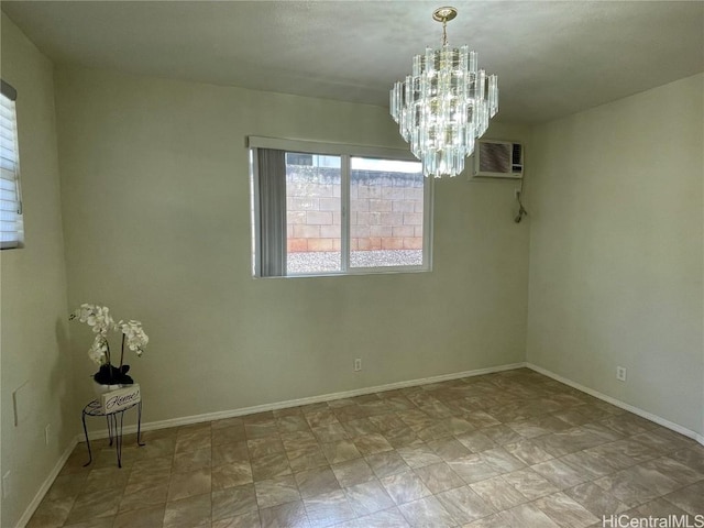 unfurnished room featuring a chandelier and a wall unit AC