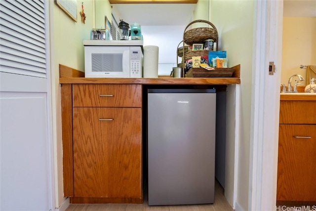 bar with refrigerator and sink