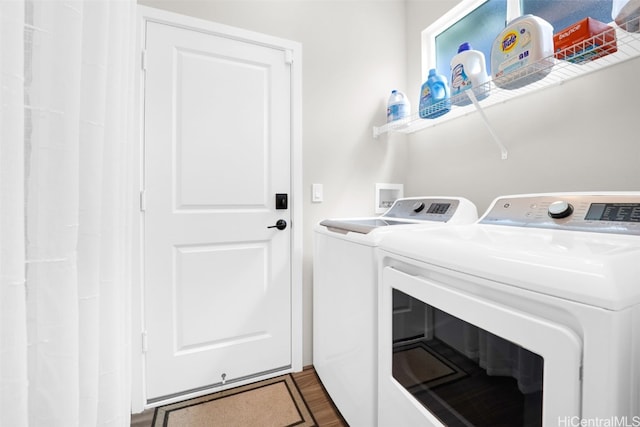 laundry room featuring dark hardwood / wood-style floors and independent washer and dryer