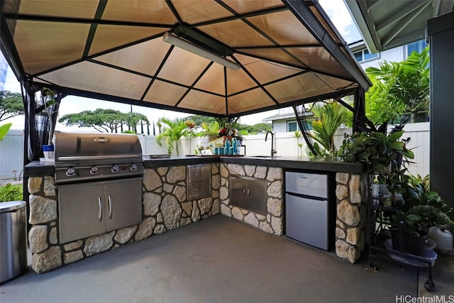 view of patio featuring a gazebo, a grill, and a wet bar