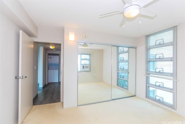 unfurnished bedroom featuring carpet, a closet, and ceiling fan