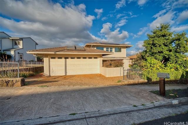 view of front of house with solar panels and a garage