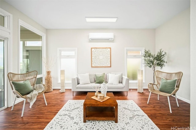 sitting room featuring hardwood / wood-style flooring and a wall unit AC