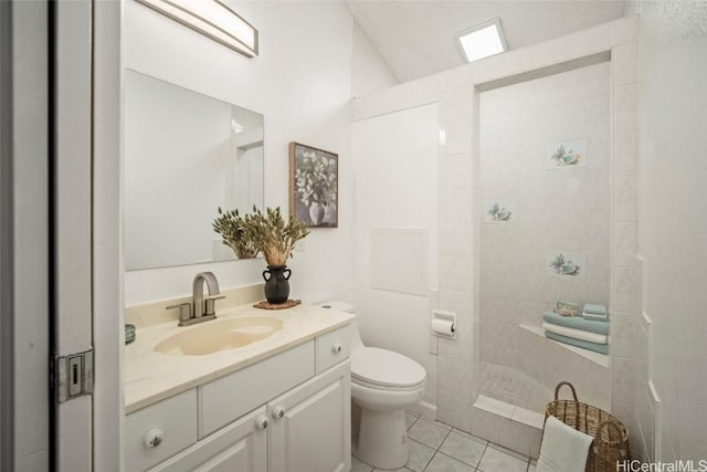 bathroom with tile patterned flooring, vanity, and toilet