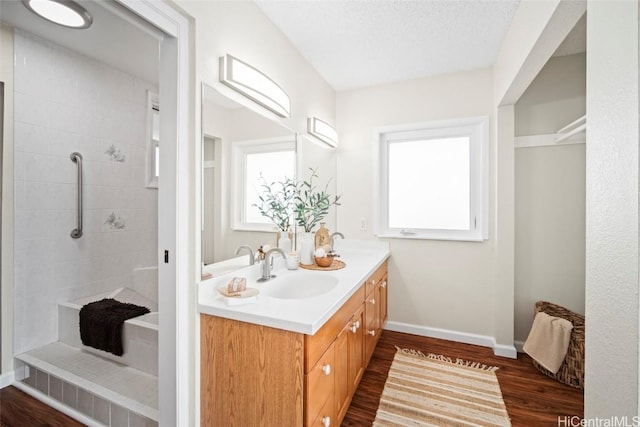 bathroom featuring hardwood / wood-style floors, vanity, and a textured ceiling