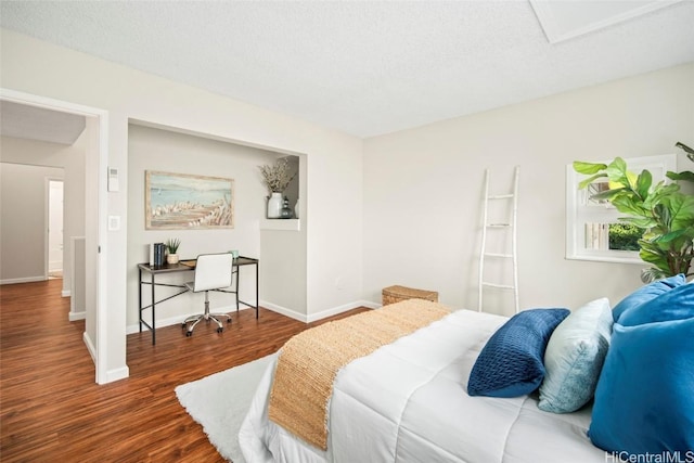 bedroom featuring a textured ceiling and dark hardwood / wood-style floors