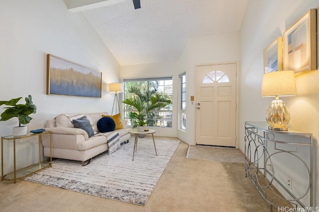 carpeted entrance foyer featuring beamed ceiling, a textured ceiling, and high vaulted ceiling