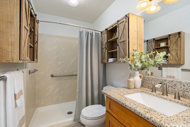 bathroom featuring a shower with curtain, toilet, and vanity