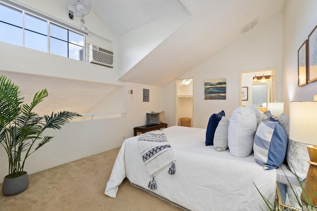 bedroom with carpet flooring, a walk in closet, a wall mounted air conditioner, and lofted ceiling