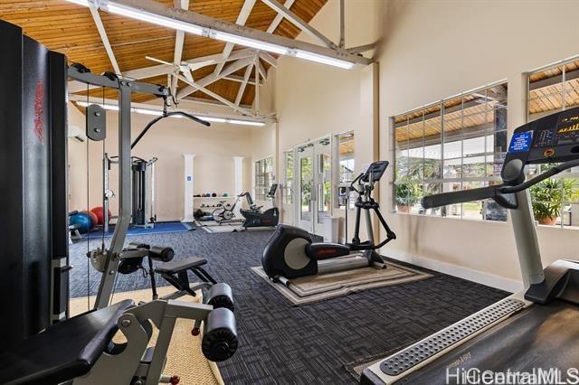 workout area with wooden ceiling and high vaulted ceiling