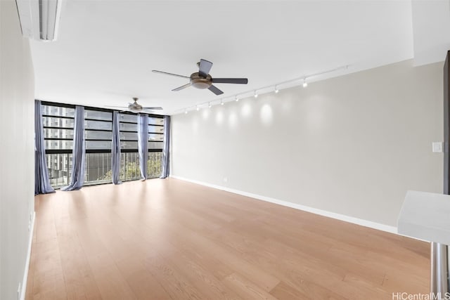 unfurnished room featuring ceiling fan, rail lighting, and light hardwood / wood-style flooring