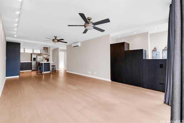 living room featuring ceiling fan, light wood-type flooring, rail lighting, and a wall mounted AC