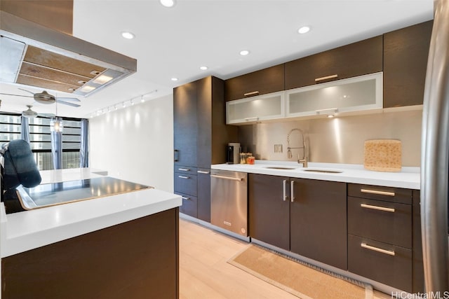 kitchen with sink, light hardwood / wood-style flooring, dark brown cabinets, island exhaust hood, and stainless steel appliances