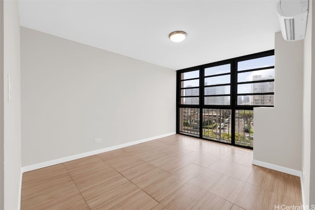 tiled spare room with expansive windows and a healthy amount of sunlight