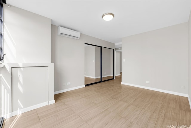 unfurnished room featuring a wall mounted air conditioner