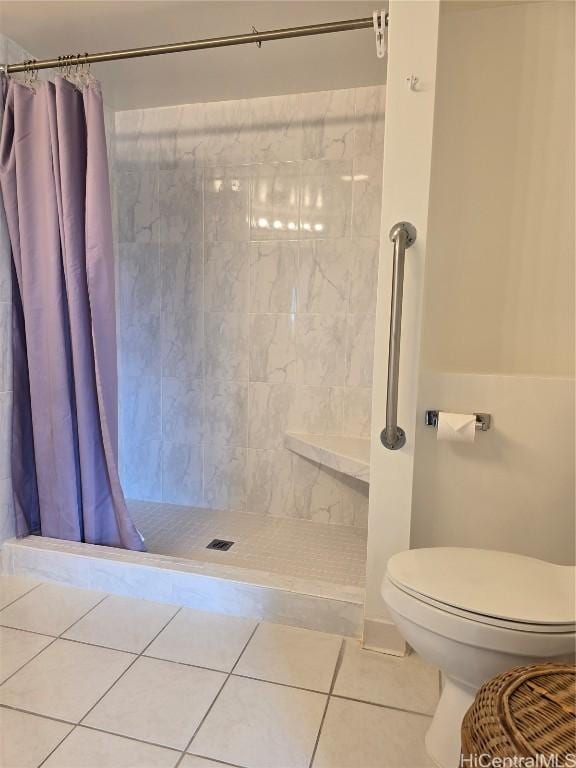 bathroom featuring tile patterned flooring, a shower with shower curtain, and toilet