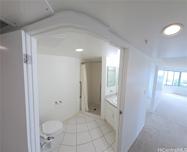 bathroom with a shower with shower curtain, tile patterned floors, vanity, and toilet