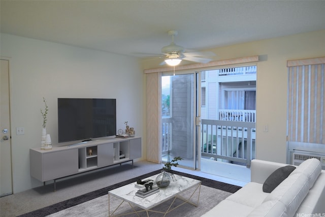 carpeted living area with a ceiling fan