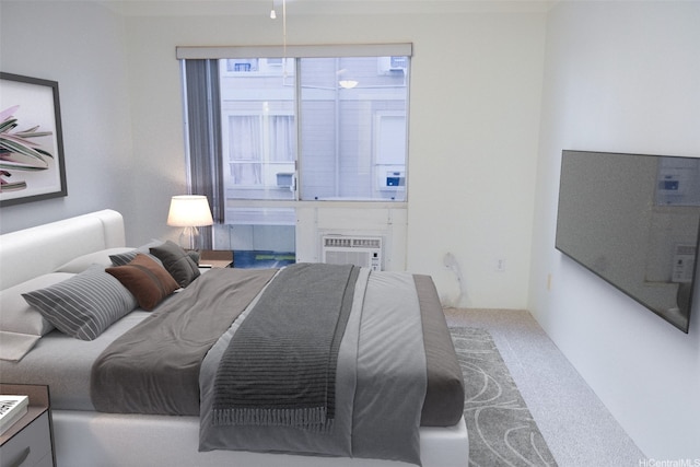 bedroom with carpet floors and a wall mounted AC