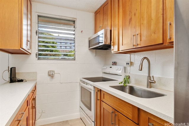 kitchen featuring sink, light tile patterned floors, and white electric range oven