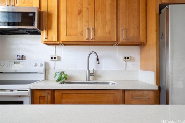 kitchen featuring decorative backsplash, sink, and stainless steel appliances