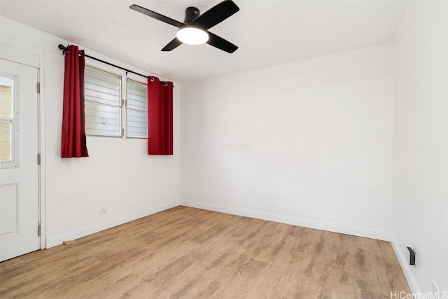 empty room featuring ceiling fan, light hardwood / wood-style floors, and a textured ceiling