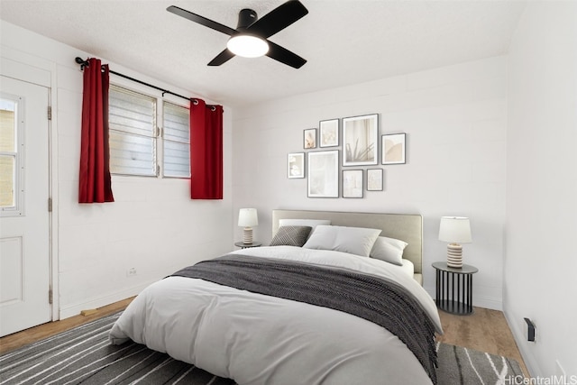 bedroom with ceiling fan and dark hardwood / wood-style floors