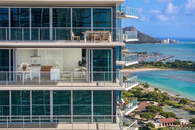 rear view of house with a water view and a beach view