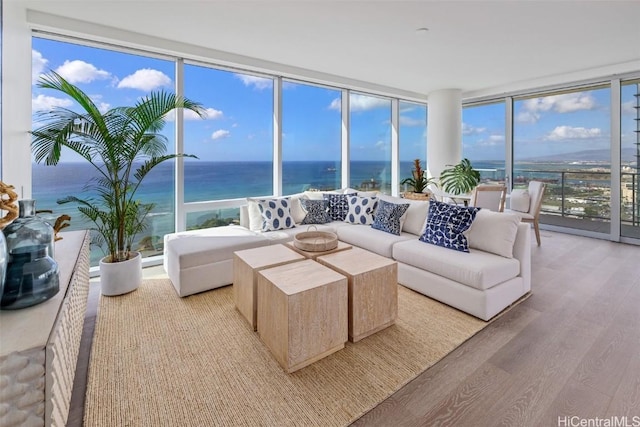 sunroom / solarium featuring a water view