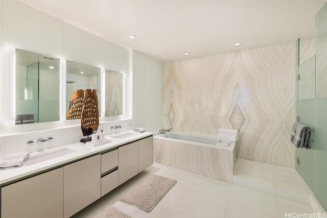 bathroom featuring tile patterned flooring, vanity, separate shower and tub, and tile walls