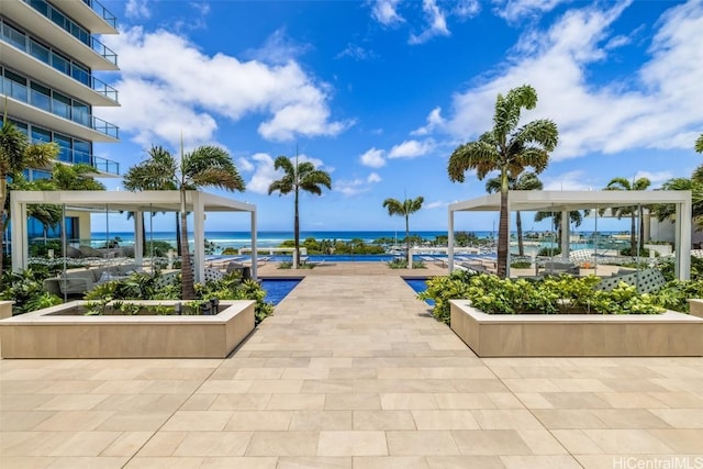 view of home's community with a patio area and a water view