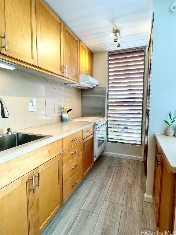 kitchen with sink, white electric range, and light wood-type flooring