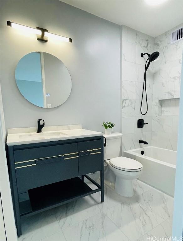 full bathroom with vanity, tiled shower / bath combo, and toilet